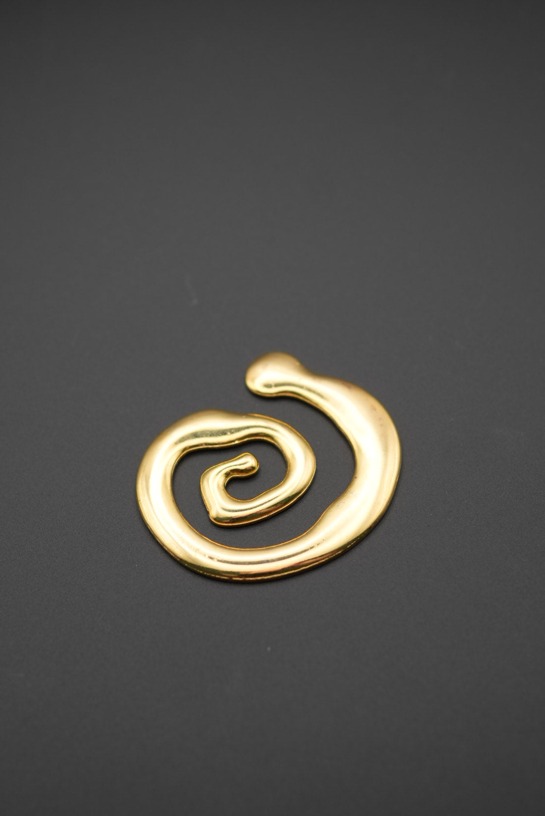 Broche rojoado en forma de espiral con acabado brillante vista lateral