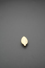 Tirador dorado con forma de hoja en perspectiva lateral